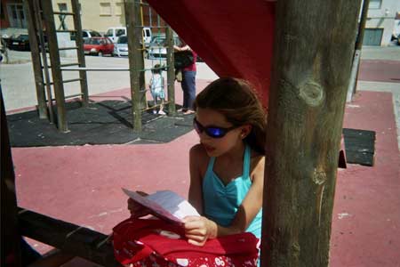 One of the participants of the kid's program reads the instructions to be able to start to keep the track